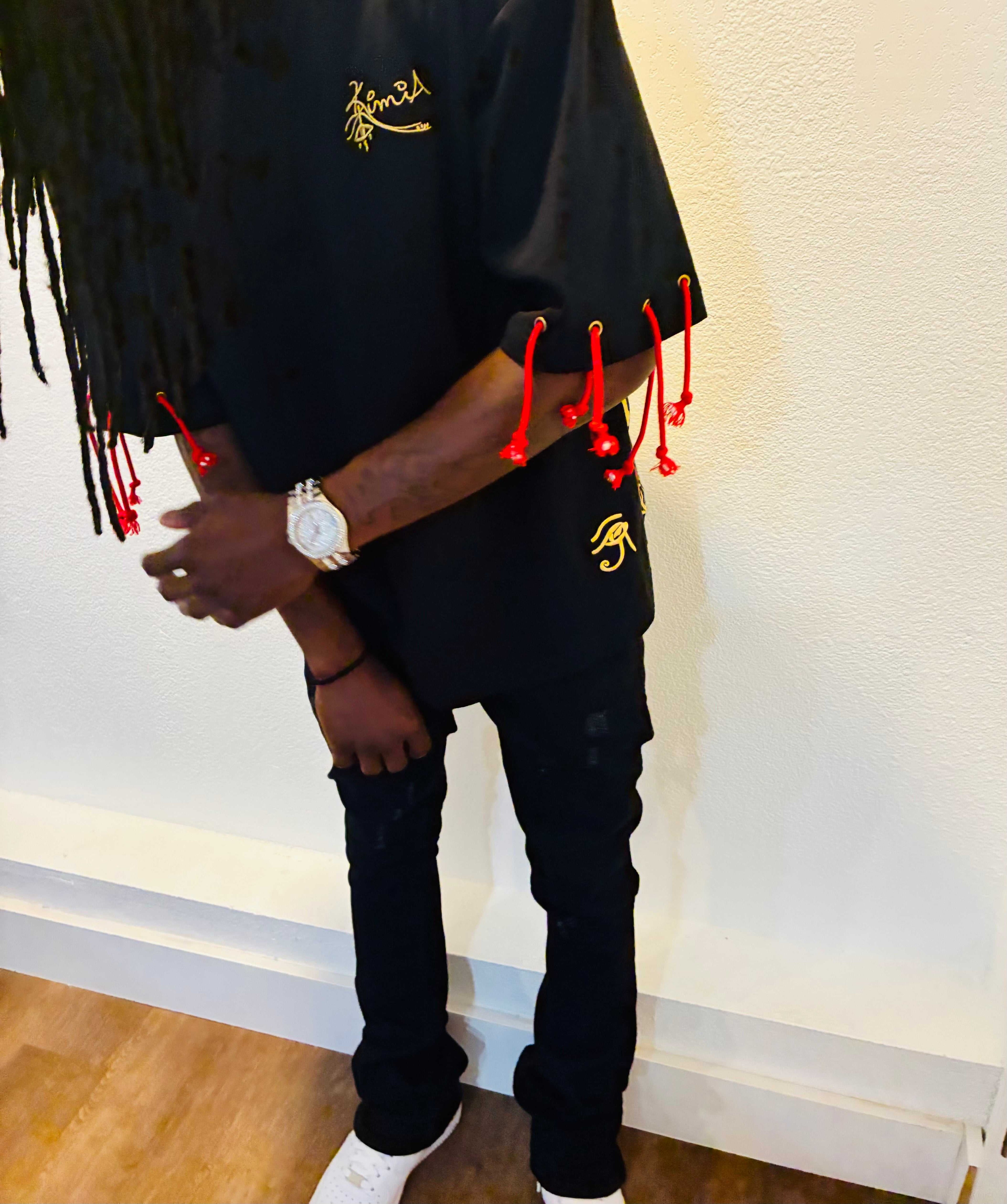 KIMIA Graffiti Tee - Luxury Streetwear front view featuring embroidered gold logo and Eye of Horus, with red rope accents on black premium fabric.